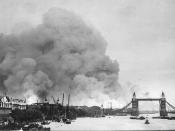 View along the River Thames towards smoke rising from the London docklands after an air raid during the Blitz.