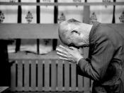 A man praying at a Japanese Shintō shrine.