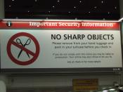 No sharp objects sign at Gatwick Airport.