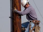 Cropped version:A worker climbing down an electricity pole, taken in Urbana, IL