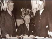 English: United States President (center) signs the with Representative (left) and Senator (right).