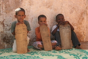 Young boys taking Qur'an lessons from wooden tablets in Mauritania, West Africa.