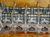 English: Image of a cylinder head from a Honda K20 showing components of the i-VTEC system.