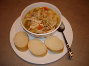 A homemade chicken noodle soup with bread