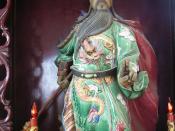 A Guan Yu statue holding the guan dao in the right hand.