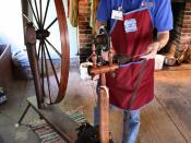 Spinning wool on a great wheel at a demonstration in the Conner Prairie living history museum loom house