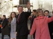 US President Bill Clinton (center with hand up), first lady Hillary Rodham Clinton to right of photo; their daughter Chelsea Clinton to left. On procession in public. The President, First Lady, and Chelsea on parade down Pennsylvannia Avenue on Inaugurati