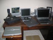 Desk full of laptop computers