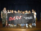 English: Pearl Harbor, Hawaii (May 31, 2005) – Master-at-Arms 1st Class Stacey Carfley stands with her recent class of Drug Abuse Resistance Education (D.A.R.E.) program graduates at Pearl Harbor Elementary School. Seventy-eight students graduated f