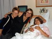 Midwife and Jessica Breese, a Certified Nurse Midwife from Colorado, pose with new mother Amy and her son Austin.