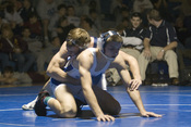 Two high school students wrestling (collegiate, scholastic, or folkstyle) in the United States. Originally uploaded by Wikiman86 on the English Wikipedia project at http://en.wikipedia.org.