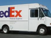English: A FedEx Express delivery truck in a shopping center parking lot in Redwood City.