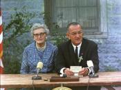 Signing ceremony for the Elementary and Secondary Education Act at the Former Junction Elementary School, Johnson City, Texas. Lyndon B. Johnson, seated at a table with his childhood schoolteacher, Ms. Kate Deadrich Loney, is delivering prepared remarks.