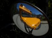 Photograph of a school bus cross-view mirror As reflected in the school vehicle's side mirror.