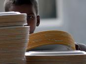 This young man, barely 7 yrs old, is piling up plates at a luncheon...I could see hunger in his eye...