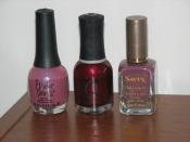 English: Three bottles of different nail polish colors and brands.