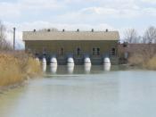 English: Pumping station that takes water from Utah Lake and puts it into the Jordan River. Utah Lake is on other side of building with the Jordan River shown.