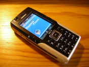 English: Siemens SXG75 mobile phone, Metallic Black version. The icons on the uppper status bar on the display have been changed from the original orange to blue, via software modding.