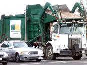 A standard Waste Management Inc. front-loading garbage truck in San Jose, California