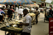 A Douala street vendor prepares his goods in hopes of making a sale Nov 19, 2006 in , Cameroon, Africa. Vendors often sell many items in small quantities so more customers can afford to purchase them.