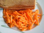 Cheetos on a plate with a sandwich