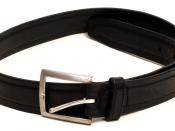 English: A worn, black leather belt with buckle.