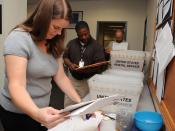 English: MILLINGTON, Tenn. (May 18, 2010) Shaunna Brooks, left, Anthony Anderson and Jim Murray, customer service center agents, sort through selection board packages at Navy Personnel Command. The center has processed 40,000 selection board packages duri