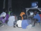 Children watch television in a village in rural Mali.