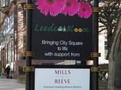 English: Leeds in Bloom sponsorship sign The sign is bigger than the planter it's fixed to. Sponsored by Yorkshire's leading divorce lawyers.