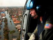 A U.S. Coast Guardsman searches for survivors in New Orleans in the aftermath of Hurricane Katrina