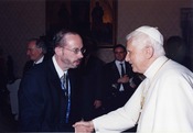 John L. Allen, Jr. with Pope Benedict XVI. John Allen is multi-awarded journalist, who is known for his objectivity. He is a vaticanista, i.e. a journalist specializing on Vatican affairs.