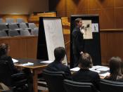 English: A student delivers a closing argument during a mock trial competition.