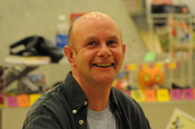 English: Nick Hornby signing books at Central Library, Seattle, Washington.