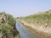 English: Water flows through an irrigation canal near Fira Shia, Iraq that once had barely enough water for farmers to use for subsistence farming.