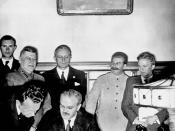 Soviet Foreign Minister Molotov signs the German-Soviet non-aggression pact; Joachim von Ribbentrop and Josef Stalin stand behind him, Moscow, August 23, 1939
