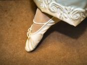 A ballet slipper (not a pointe shoe) displayed by a bride