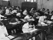 English: School children doing exams inside a classroom, 1940. Children sitting at their school desks in a classroom doing scholarship examinations, 16 April 1940.