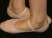 Ballet shoes, showing the dancer's feet in fifth position.
