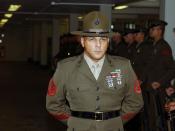 English: US Marine Corps Senior Drill Instructor Staff Sergeant T. Warren, Platoon 1057, Bravo Company, 1st Recruit Training Battalion, stands at parade rest while waiting for the Battalion Commander aboard , . The Battalion Commander is inspecting the B 