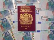 UK biometric passport on pile of Euro currency