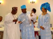 English: An Igbuzo child naming ceremony in Washington DC, USA. Parents of the child confer with the Diokpa (Head of he family) on the names of the child