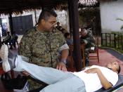 US Navy 040627-N-1464F-003 U.S. Naval Reserve Lt. Anthony Edwards checks the mobility of a local Peruvian woman during a medical evaluation