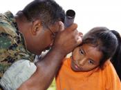 US Navy 040627-N-1464F-011 U.S. Naval Reservist Lt. Anthony Edwards provides a local Peruvian girl with a medial check-up