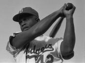 Jackie Robinson swinging a bat in Dodgers uniform, 1954.