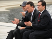 Actor Tom Hanks, center, points to 250 veterans at the World War II Memorial March 11, during a speech by HBO co-president Richard Plepler (not pictured). Fellow executive produce Steven Spielberg is seated on Hanks' right.