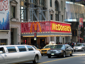 McDonalds on West 42nd Street in Times Square, New York City. Madame Tussauds wax museum is seen to the right. Number plates on cars have been blurred. Category:Images of New York City