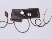 Aneroid sphygmomanometer with stethoscope, used for auscultatory blood pressure measurement.
