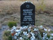 Memorial for Margot and Anne Frank at the former Bergen-Belsen site, along with floral and pictorial tributes.