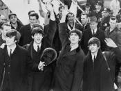 English: The Beatles wave to fans after arriving at Kennedy Airport.