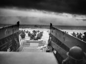 A LCVP (Landing Craft, Vehicle, Personnel) from the U.S. Coast Guard-manned USS Samuel Chase disembarks troops of Company E, 16th Infantry, 1st Infantry Division (The Big Red One) wading onto the Fox Green section of Omaha Beach on the morning of June 6, 